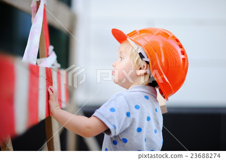 Little builder in hardhats working outdoors Little builder in hardhats working outdoors 23688274
