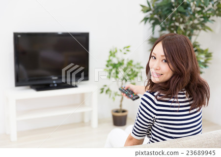 A woman watching TV 23689945
