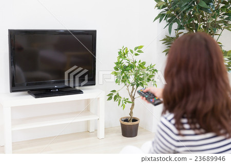 A woman watching TV 23689946