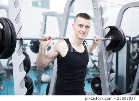 Athletic man with a dumbells in gym 23692837