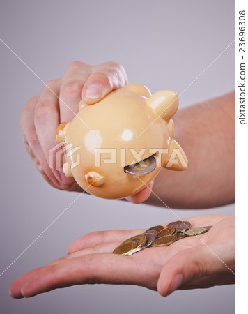Male hands with coins and piggybank Male hands with coins and piggybank 23696308