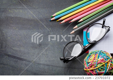 Supplies and glasses over chalk board Supplies and glasses over chalk board 23701072