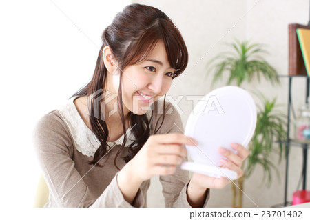 A young girl who is pleased that the trouble of the skin is improved A young girl who is pleased that the trouble of the skin is improved 23701402