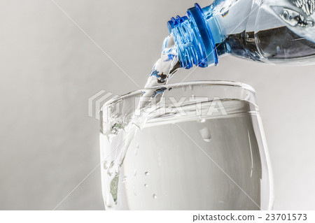 Pouring water from bottle Pouring water from bottle 23701573