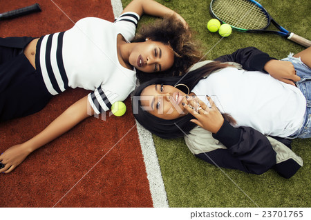 young pretty girlfriends hanging on tennis court young pretty girlfriends hanging on tennis court 23701765
