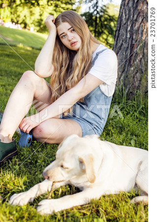 young attractive blond woman playing with her dog young attractive blond woman playing with her dog 23701769