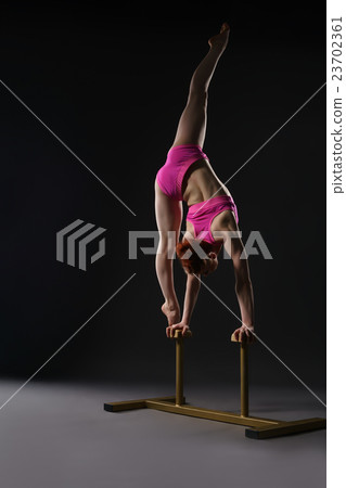 Tightrope walker training. Photo on gray backdrop 23702361