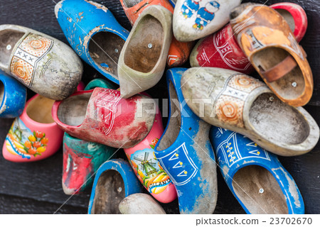 Traditional dutch wooden shoes hanging at a wall Traditional dutch wooden shoes hanging at a wall 23702670