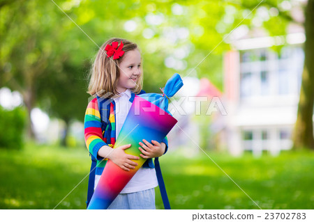 Little child with candy cone on first school day Little child with candy cone on first school day 23702783