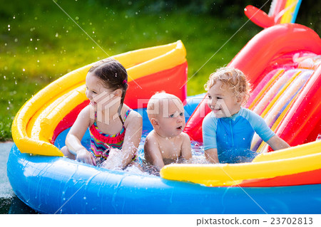 Kids playing in inflatable swimming pool Kids playing in inflatable swimming pool 23702813
