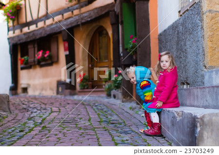 Children in historical city center in France Children in historical city center in France 23703249