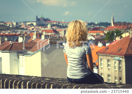 girl sitting on the roof of a house girl sitting on the roof of a house 23715440