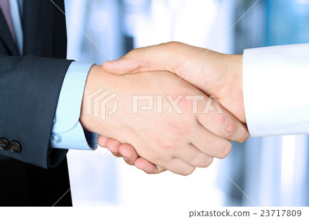 image of a firm handshake  between two colleagues 23717809