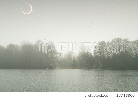 eclipse of the sun in the autumn mist. eclipse of the sun in the autumn mist. 23718806