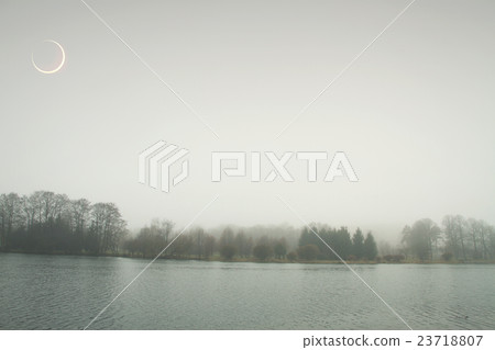 eclipse of the sun in the autumn mist. eclipse of the sun in the autumn mist. 23718807