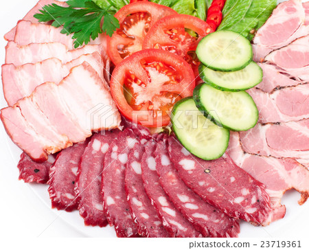 various sliced sausages with vegetables 23719361