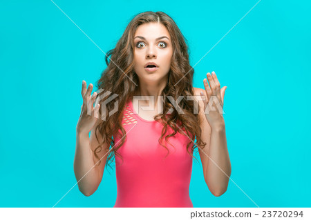 Portrait of young woman with shocked facial Portrait of young woman with shocked facial 23720294