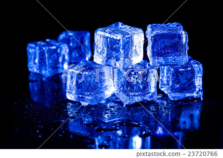 ice cubes in blue light on a black table. ice cubes in blue light on a black table. 23720766