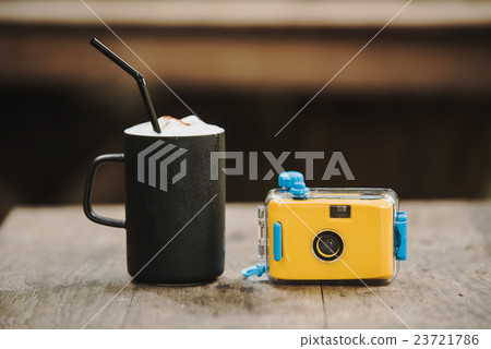 camera with coffee in cafe on wood table camera with coffee in cafe on wood table 23721786