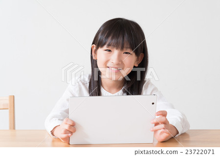 Elementary school student watching tablet by dining Elementary school student watching tablet by dining 23722071