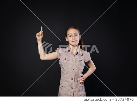 Small girl has idea. Child shows finger up, eureka 23724076