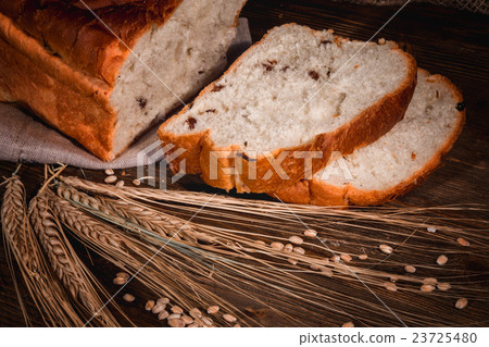 sliced white buns and ears of wheat 23725480