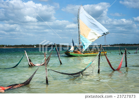 Sail boat and hammocks at the Paradise Lake Sail boat and hammocks at the Paradise Lake 23727873