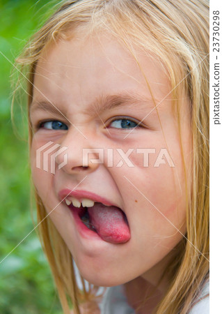 Cute girl with put out tongue 23730298
