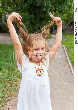 Girl makes faces imitate witch 23730299