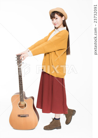 young musician holding a guitar 23732091