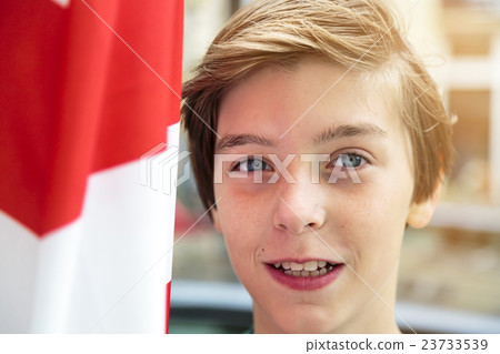 portrait of a smiling boy with red and white flag beside 23733539