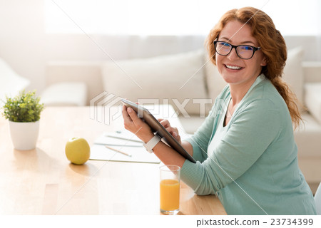 Positive woman working at home Positive woman working at home 23734399