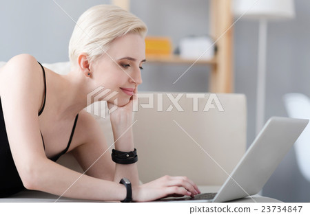 Profile of woman working on laptop Profile of woman working on laptop 23734847