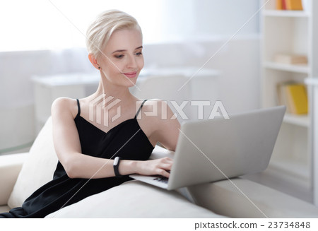 Contented woman working on laptop Contented woman working on laptop 23734848