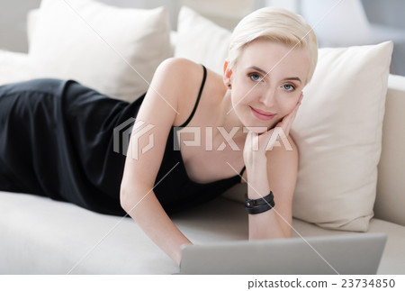 Woman with laptop looking at camera Woman with laptop looking at camera 23734850