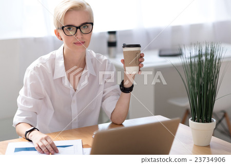 Woman having coffee pause while working Woman having coffee pause while working 23734906