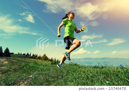 young woman trail runner running on mountain peak young woman trail runner running on mountain peak 23740478