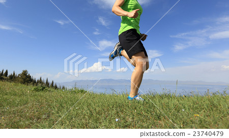 young woman trail runner running on mountain peak young woman trail runner running on mountain peak 23740479