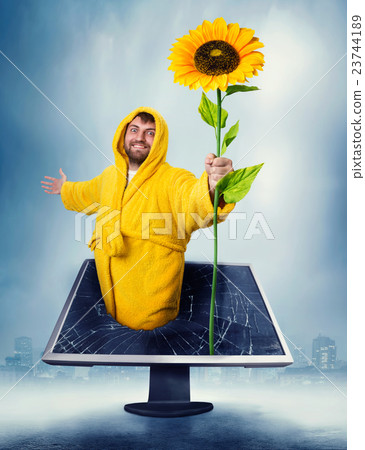Man in the monitor holding sunflower Man in the monitor holding sunflower 23744189