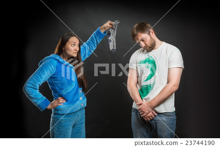 Woman holding a dirty sock 23744190