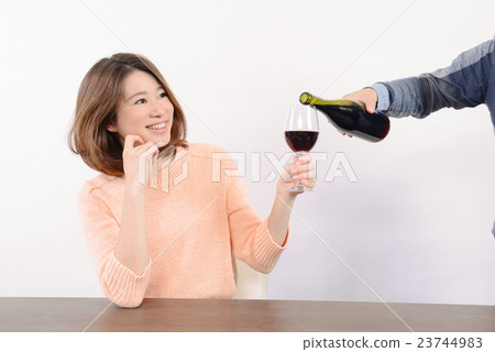 A young woman poured wine 23744983