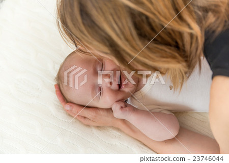 Smiling newborn baby and mother 23746044