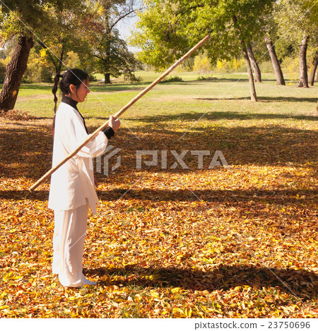 Woman holding stick 23750696