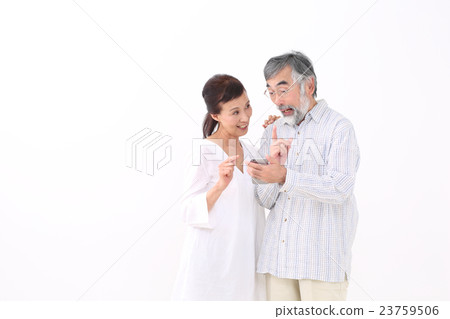 A couple looking at smartphones A couple looking at smartphones 23759506