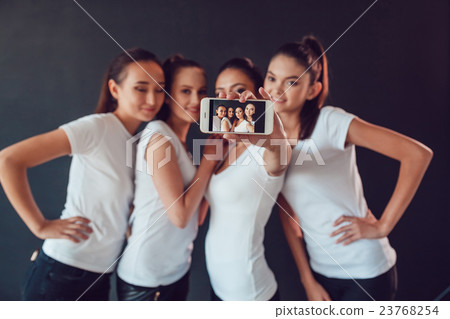 Positive friends portrait of happy girls making Positive friends portrait of happy girls making 23768254