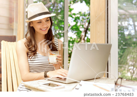 Cheerful woman using laptop 23768483
