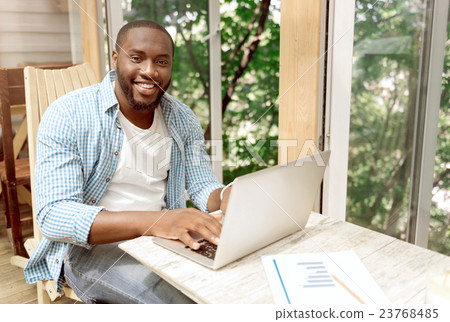 Delighted smiling woman using laptop 23768485