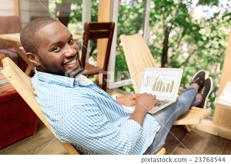 Positive handsome man sitting in the chair Positive handsome man sitting in the chair 23768544
