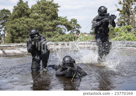 Stock Photo: Spec ops police officers SWAT in the water