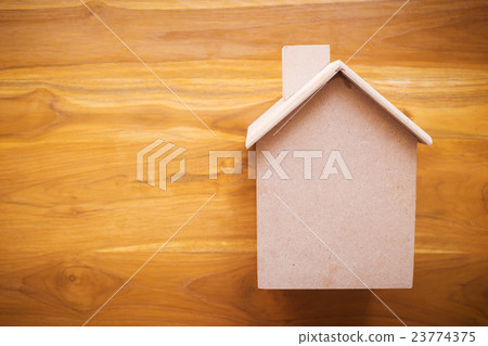 small wood house model on brown wooden background small wood house model on brown wooden background 23774375